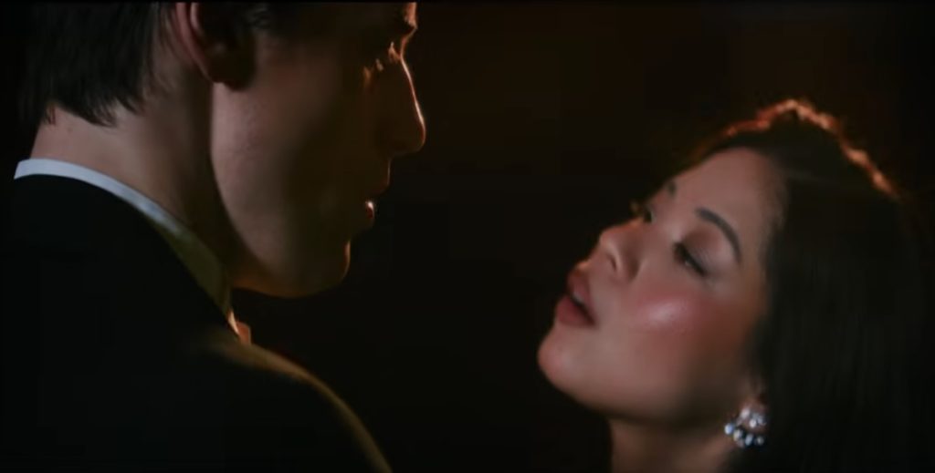 Reeve Carney and Eva Noblezada sing close up in The Great Gatsby