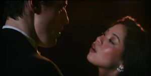 Reeve Carney and Eva Noblezada sing close up in The Great Gatsby