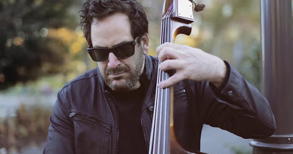 Man in sunglasses playing upright bass